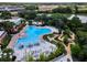 Aerial view of community pool area with lounge chairs and mini golf area at 434 Captiva Dr, Davenport, FL 33896