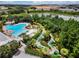 Aerial view of a resort-style pool and a mini golf area surrounded by green landscaping at 434 Captiva Dr, Davenport, FL 33896