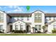 Charming townhome featuring neutral colors, well-maintained landscaping, and inviting front entrance at 434 Captiva Dr, Davenport, FL 33896