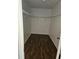 Walk-in closet with dark wood floors and metal shelving at 4758 Wyresdale St, Orlando, FL 32808
