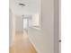 Upstairs hallway with light floors and walls leading to various rooms at 4758 Wyresdale St, Orlando, FL 32808
