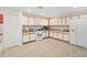 Well-lit kitchen featuring white cabinets, modern appliances, and light tile flooring at 4758 Wyresdale St, Orlando, FL 32808