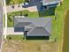 Aerial view of a home highlighting the roof, landscaping, and proximity to a lake at 224 Valencia Ridge Dr, Auburndale, FL 33823