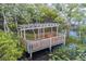 Scenic view of a wooden pier with a covered bench overlooking the tranquil water and lush greenery at 7127 Harmony Square S Dr # 7127, Harmony, FL 34773