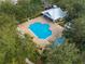 Aerial view of a community pool featuring ample seating and a covered pavilion perfect for relaxing by the water at 7127 Harmony Square S Dr # 7127, Harmony, FL 34773