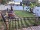 Picture of fenced backyard with a custom brick fire pit in a fenced backyard at 438 Spike Ct, Kissimmee, FL 34759