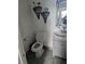 Small bathroom with decorative wall art, featuring a classic white sink and toilet for everyday use at 438 Spike Ct, Kissimmee, FL 34759