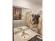 Bathroom features a gray vanity with tile floors, modern fixtures, and decorative shower curtain at 438 Spike Ct, Kissimmee, FL 34759