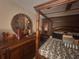 Bedroom features a four-post bed frame, decorative pillows and linens, and unique wall decor at 438 Spike Ct, Kissimmee, FL 34759