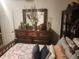 Bedroom features a wood bed frame with decorative pillows and a floral comforter at 438 Spike Ct, Kissimmee, FL 34759