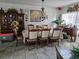 View of dining room showcasing set with eight chairs, china cabinet, and decorative chandelier at 438 Spike Ct, Kissimmee, FL 34759