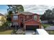 Two-story house with a brown garage door and landscaped yard at 438 Spike Ct, Kissimmee, FL 34759