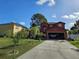 Charming two-story home with a spacious driveway, attached garage and luscious front yard at 438 Spike Ct, Kissimmee, FL 34759
