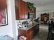 Kitchen view with wood cabinets, granite counters, and stainless-steel microwave at 438 Spike Ct, Kissimmee, FL 34759