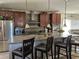Modern kitchen with granite countertops, breakfast bar, stainless steel appliances, and ample cabinet space at 438 Spike Ct, Kissimmee, FL 34759