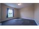 Simple bedroom with carpet flooring and a window at 464 Bridgewater Ct, Kissimmee, FL 34758