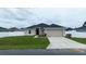 Single-story home with a two-car garage and nice lawn at 464 Bridgewater Ct, Kissimmee, FL 34758