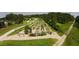 Aerial view of an organized community garden with raised beds and walking paths surrounded by lush greenery at 6829 Sundrop St, Harmony, FL 34773