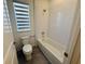 Full bathroom features tile flooring, a tub and shower combo, and modern toilet at 13193 Tollcross Way, Winter Garden, FL 34787