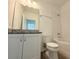 Bathroom featuring granite counters, white cabinets, and updated fixtures at 13193 Tollcross Way, Winter Garden, FL 34787