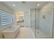 Bright bathroom featuring a soaking tub, walk-in shower and double vanity at 13193 Tollcross Way, Winter Garden, FL 34787
