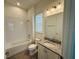Bathroom featuring granite countertops, tile floors, and a tub at 13193 Tollcross Way, Winter Garden, FL 34787