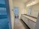En-suite bathroom featuring granite counters, white cabinets, and updated fixtures at 13193 Tollcross Way, Winter Garden, FL 34787