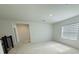 Bright bonus room with plush carpeting, neutral walls, and a large window with modern horizontal blinds at 13193 Tollcross Way, Winter Garden, FL 34787