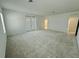 Large bonus room with plush carpeting, neutral walls, double doors to balcony and an ensuite bathroom at 13193 Tollcross Way, Winter Garden, FL 34787
