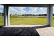 Covered patio featuring brick pavers and a scenic view of the lush green lawn and the shimmering lake beyond at 13193 Tollcross Way, Winter Garden, FL 34787