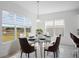 Dining room with modern decor, natural lighting, and views of a pond at 13193 Tollcross Way, Winter Garden, FL 34787