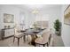 Elegant dining room featuring a marble table, plush chairs, and stylish decor at 13193 Tollcross Way, Winter Garden, FL 34787