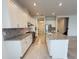 Modern kitchen with granite island, stainless appliances, and white cabinets at 13193 Tollcross Way, Winter Garden, FL 34787