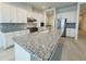 Stylish kitchen with granite island, stainless steel appliances and white cabinets at 13193 Tollcross Way, Winter Garden, FL 34787