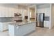 Spacious kitchen featuring stainless steel appliances and a granite island at 13193 Tollcross Way, Winter Garden, FL 34787