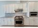 Modern kitchen with stainless steel appliances and stylish white cabinets at 13193 Tollcross Way, Winter Garden, FL 34787