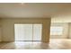Bright living room with sliding glass door and wood-look tile flooring at 13193 Tollcross Way, Winter Garden, FL 34787