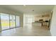 Open-concept living space with access to the kitchen and outdoor patio overlooking a pond at 13193 Tollcross Way, Winter Garden, FL 34787