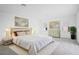 This bedroom is brightly lit and features a king-size bed, stylish decor, and a large potted plant at 13193 Tollcross Way, Winter Garden, FL 34787