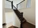 Staircase with dark wood steps and black metal railing at 13193 Tollcross Way, Winter Garden, FL 34787