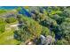 Aerial view of lush trees surrounding a property, featuring glimpses of the roof, backyard, and driveway at 4321 Rummell Rd, St Cloud, FL 34769