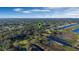 Aerial view of a waterfront lot with mature trees and marshland on a sunny day under a blue sky at 4321 Rummell Rd, St Cloud, FL 34769