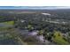 A serene, natural landscape showcasing a marshy lake, with a neighborhood nestled among trees and greenery in the background at 4321 Rummell Rd, St Cloud, FL 34769