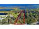 Aerial view of property outlined in red showing location including proximity to water, foliage and a nearby road at 4321 Rummell Rd, St Cloud, FL 34769