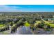 Aerial shot presenting the residence in a leafy setting by tranquil waters at 4321 Rummell Rd, St Cloud, FL 34769