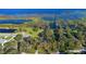 Beautiful aerial view of the property showcasing a large lot, mature trees, and proximity to a tranquil lake at 4321 Rummell Rd, St Cloud, FL 34769