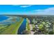 Aerial view of a canal and waterfront neighborhood with lush vegetation and a blue sky backdrop at 4321 Rummell Rd, St Cloud, FL 34769