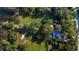 Lush green aerial view of property including the house, pool and surrounding nature at 4321 Rummell Rd, St Cloud, FL 34769
