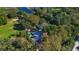 Unique aerial perspective showcasing a beautiful home with a pool surrounded by lush landscaping and mature trees at 4321 Rummell Rd, Saint Cloud, FL 34769