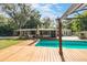 Charming backyard with inviting pool, wooden deck, and serene views at 4321 Rummell Rd, St Cloud, FL 34769